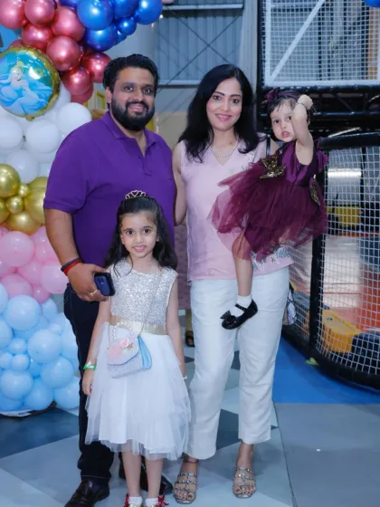 A happy family poses for a photo at a Frozen-themed party. Our events are perfect for creating lasting family portraits.
