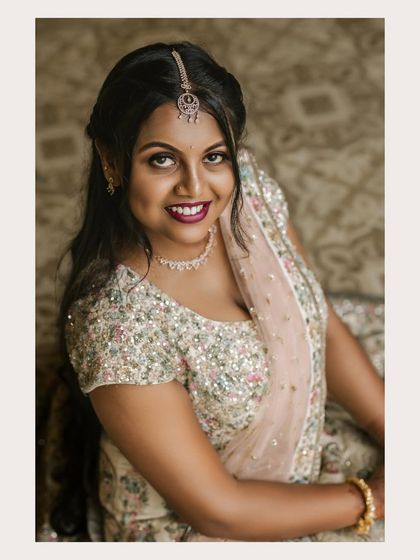 A smiling close-up portrait of the bride, capturing her happiness and beautiful engagement makeup and attire.