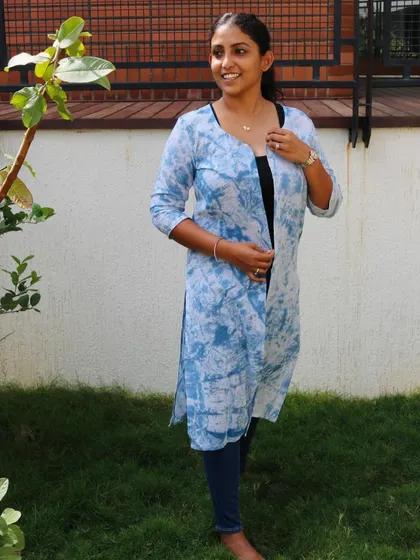 This long shrug, which I call the 'Indigo Hug,' is hand-dyed with natural indigo to create a beautiful, cloud-like pattern. It's a versatile and unique piece that can elevate any outfit.
