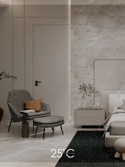 A clean view of the harmonious and minimalist bedroom. The space uses a subtle grey marble wall, a simple bed frame, and a statement armchair to create a feeling of understated luxury and calm.