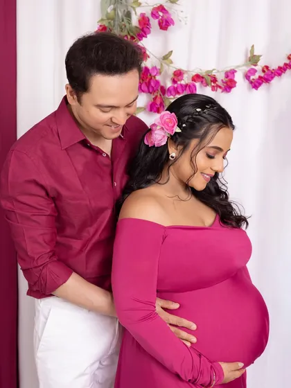 A tender portrait focusing on the couple's connection as they both look down at the baby bump.