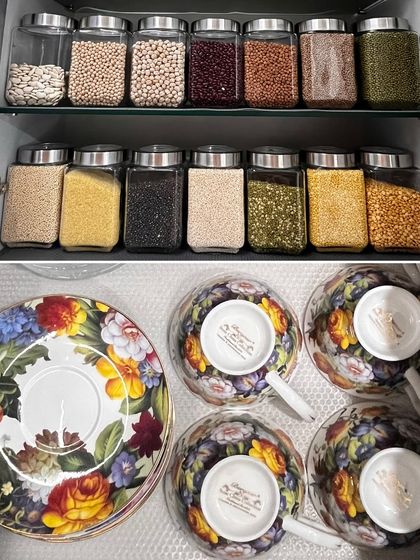 A cabinet of decanted grains sits above a drawer containing a beautiful floral tea set, showing how we organize for both function and beauty.
