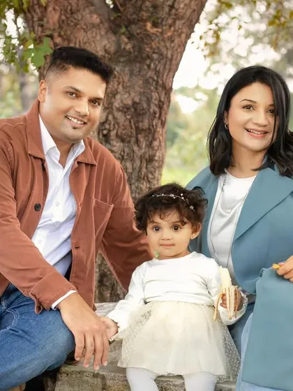 A classic family portrait taken outdoors. The natural setting provides a beautiful and timeless backdrop.