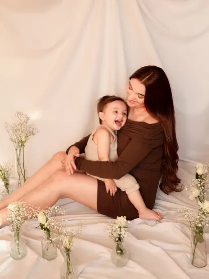 A candid moment of laughter between a mother and her son. This photo captures the genuine, unposed joy that is at the heart of their relationship.
