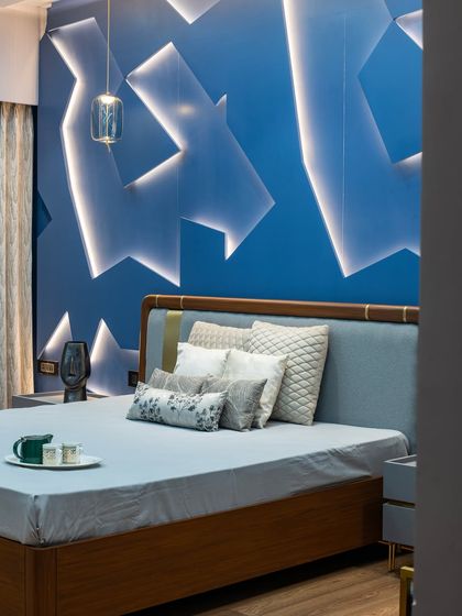 A closer look at the 3D paneled wall, where light and shadow create a captivating effect. The pendant light adds a touch of modern elegance, balancing the boldness of the feature wall.