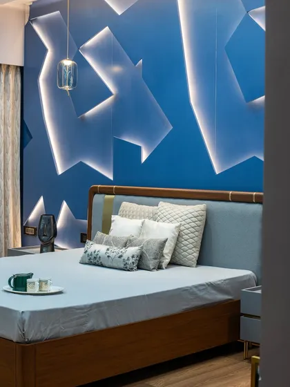 A closer look at the 3D paneled wall, where light and shadow create a captivating effect. The pendant light adds a touch of modern elegance, balancing the boldness of the feature wall.