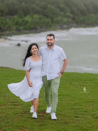 A beautiful walking shot along the cliffside path. The movement in her dress and their connected hands tell a story of a shared journey.