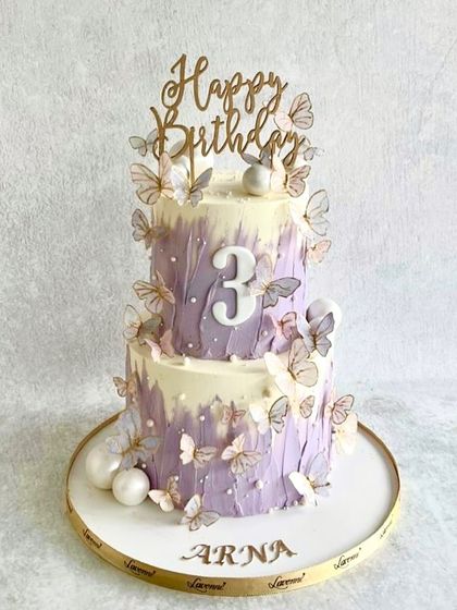 A dreamy butterfly cake for Arna's 3rd birthday. The purple ombre buttercream is decorated with delicate wafer paper butterflies, giving it a light and airy feel.