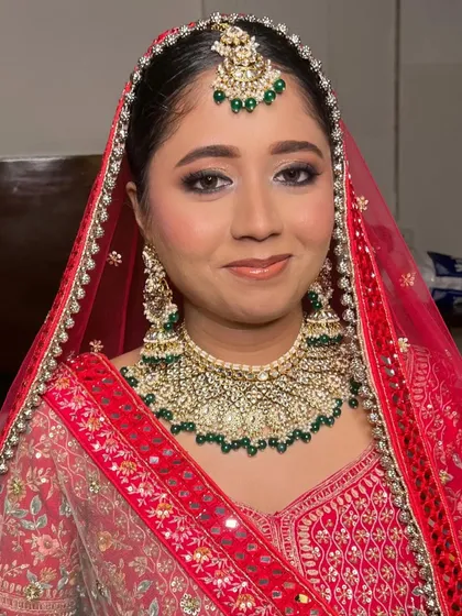 A radiant smile from this stunning bride. The soft glam makeup enhances her features beautifully, letting her happiness shine through.