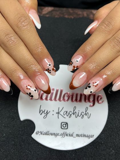 A unique take on the French manicure with multi-colored tips and delicate hand-painted flowers.