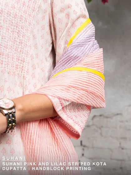 The Suhani pink and lilac striped Kota dupatta, shown here as a sleeve detail. The soft colors and lightweight fabric make it a perfect layering piece for any season.