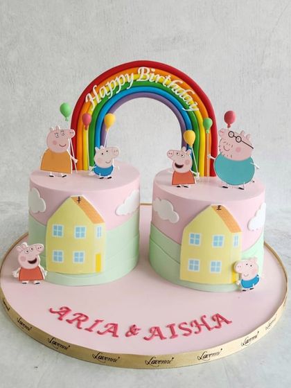 A double birthday celebration with these adorable Peppa Pig cakes. We created a shared scene with two cakes, featuring the whole Peppa Pig family enjoying a day out.