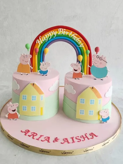 A double birthday celebration with these adorable Peppa Pig cakes. We created a shared scene with two cakes, featuring the whole Peppa Pig family enjoying a day out.