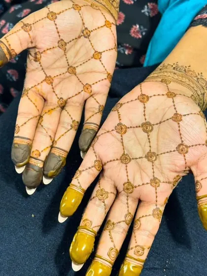 A simple and beautiful jaal pattern with floral buts, shown after the henna paste has been removed to reveal the lovely orange stain.