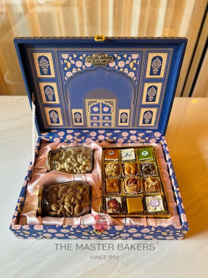 Our royal blue festive box is a statement of elegance. Inside, a satin lining holds jars of premium dry fruits and a selection of our finest assorted sweets, including baklava and chocolates.