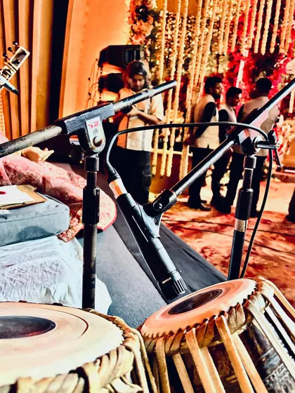 My tabla and microphone setup, ready for a show. This image captures the anticipation and excitement just before a live performance begins.
