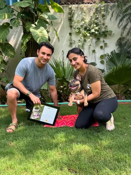 Posing with a proud French Bulldog graduate and his guardian. We work with dogs of all breeds and sizes.