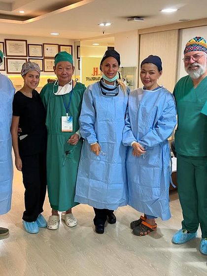 A post-surgery photo with the international faculty team in Bangkok.