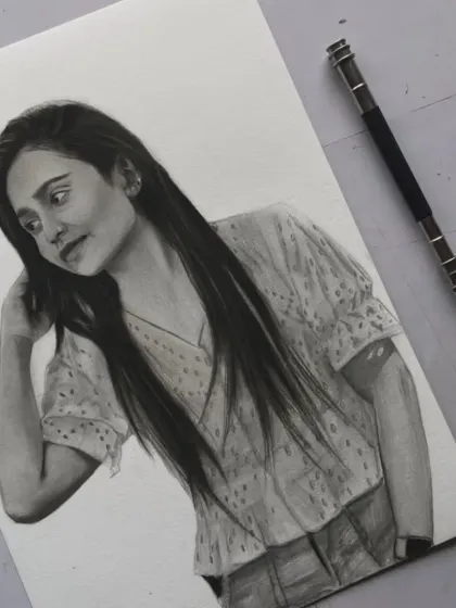 This commissioned A4 portrait features a casual pose. I worked to capture the soft texture of her top and the natural flow of her long hair.