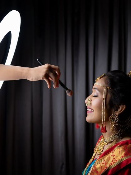A creative getting-ready shot using a ring light to frame the makeup application.