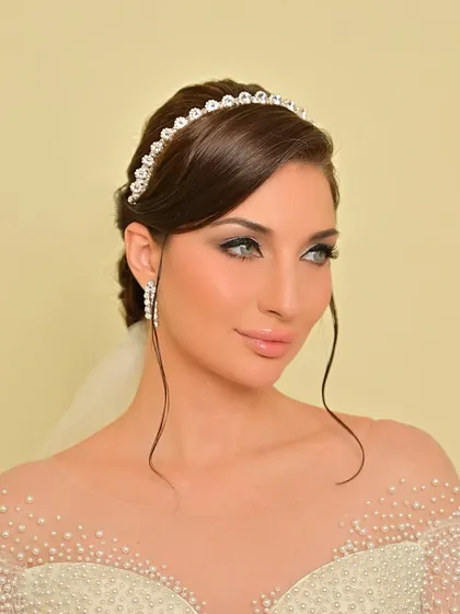 This shot highlights the bride's beautiful features, enhanced by the soft and romantic makeup.