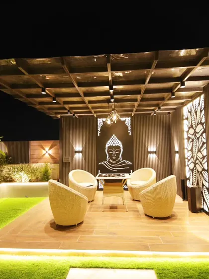 A completed pergola in Sushant Lok, Gurgaon, designed for relaxation with comfortable seating and a serene, backlit Buddha artwork.
