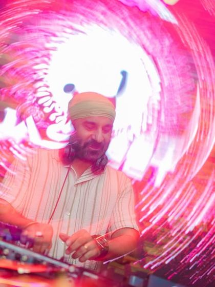 A creative long-exposure shot, creating a vortex of light around me at the DJ console.