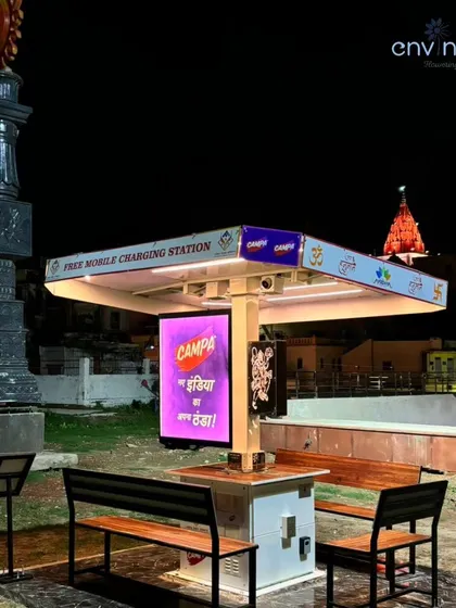 Our Smart Solar Hut at Siddhi Park, Ayodhya, illuminated at night with the Hanuman Garhi temple visible in the background. The shelter adds to the safety and convenience of this important public space.