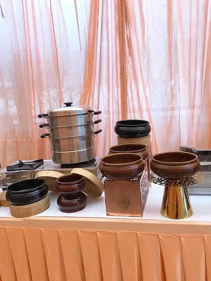 A collection of our varied serving bowls, including wooden and ceramic pieces on decorative stands, ready for a house party or small event.