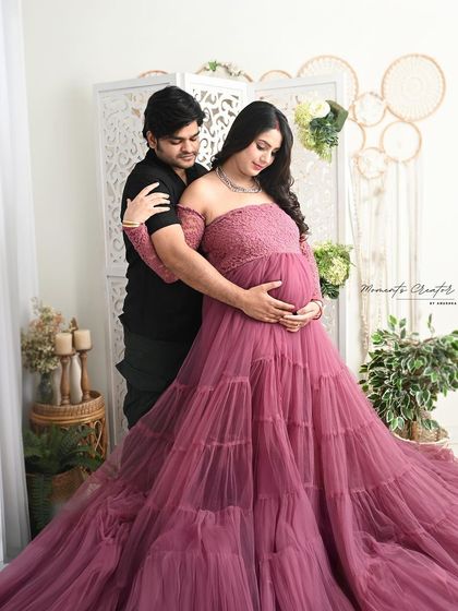 An intimate embrace in our bright, boho-themed setup. The natural light and earthy decor provide a soft and warm setting for this couple's portrait.