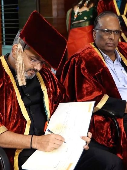 Signing certificates for the graduates, a final official act as Guest of Honour for the ceremony.