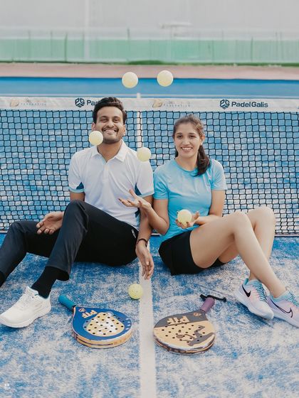 A creative shot with the couple juggling Padel balls, adding a touch of fun and action to their pre-wedding photos.