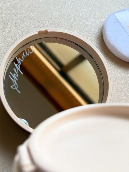 Engraving isn't just for bottles. Here, I've personalized the mirror inside a Dior compact, a satisfying surface that offers a hidden, personal touch every time it's used.