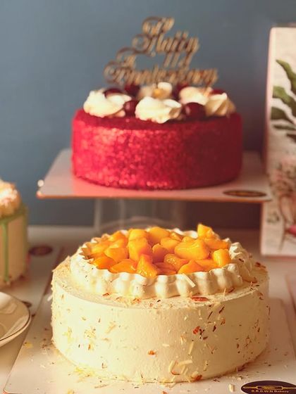 A beautiful spread of our summer cakes, featuring fresh fruit, mango, and red velvet options. There's something for everyone to enjoy.