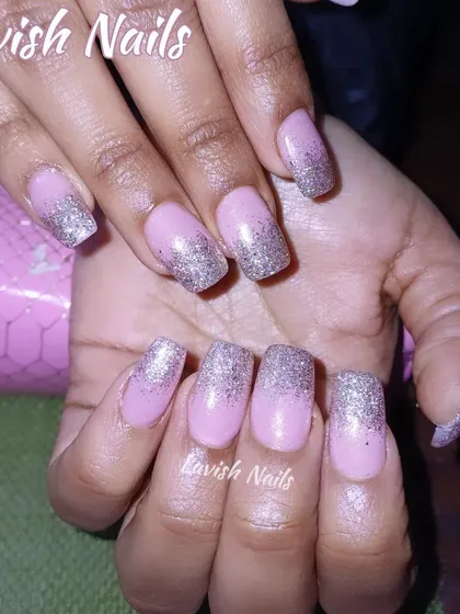 A soft pink base with a silver glitter ombre effect on square-shaped nails.