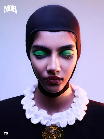 A striking beauty close-up from the 'Neo-Baroque Noir' set in MOB Journal, emphasizing the bold green eyeshadow and the clean, graphic lines of the styling.