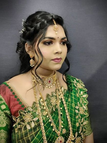 An elegant bridal portrait showcasing our student's makeup and hairstyling skills. The braided updo and perfectly blended makeup create a cohesive and polished look.