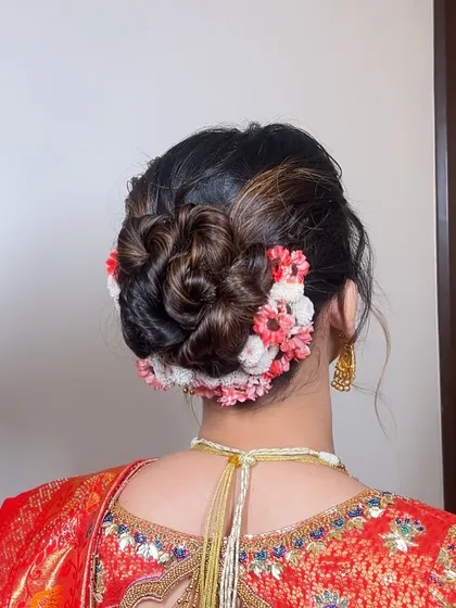 Another view of the wedding bun, highlighting the texture and the beautiful gradient of flowers wrapped around the base.