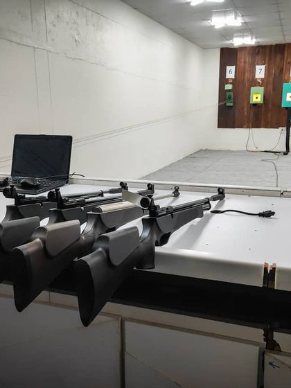 A view of our training bay with rifles ready for our students. The setup includes laptops connected to the electronic target system for live performance tracking.