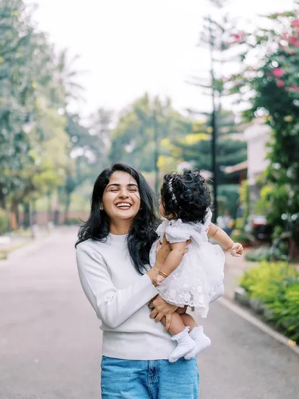 A candid, joyful moment between the aunt and her niece, full of laughter and movement.