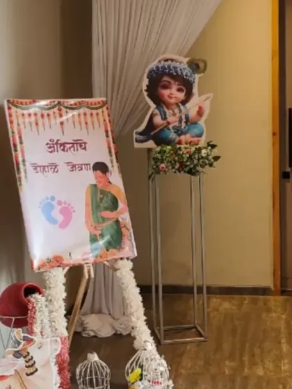 The welcome area for a 'Dohale Jevan' ceremony. It features a welcome sign on an easel and character cutouts, setting a traditional tone for the event.