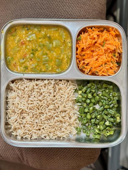 A simple, fiber-rich meal of brown rice, bottle gourd dal, and a side of sautéed carrots and beans.