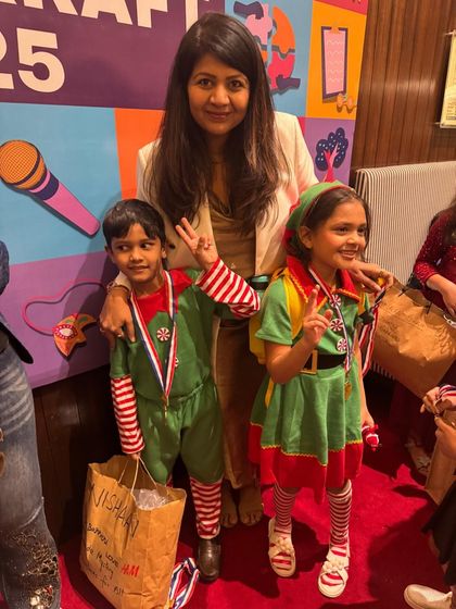 Two adorable elves celebrating their performance. The joy on their faces says it all.