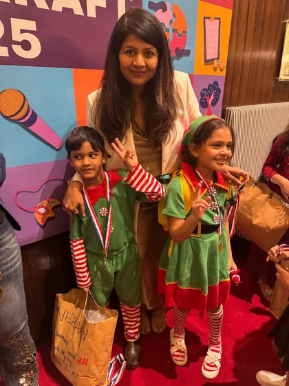 Two adorable elves celebrating their performance. The joy on their faces says it all.