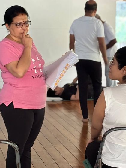 A moment of thoughtful observation during a class. I am listening to a student's question, ensuring my guidance is clear and supportive of her unique journey.