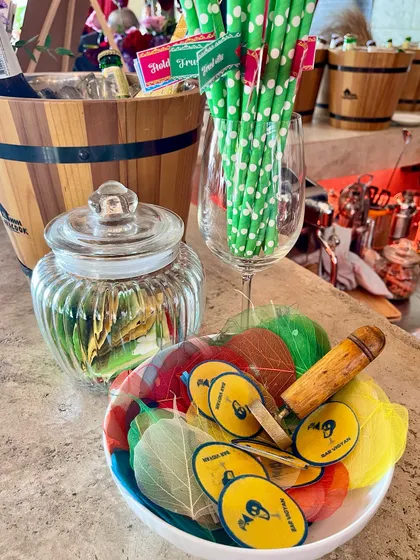 Even our bar snacks and accessories are thoughtfully presented. This bowl contains branded coasters and colorful leaf garnishes, ready to be added to drinks.