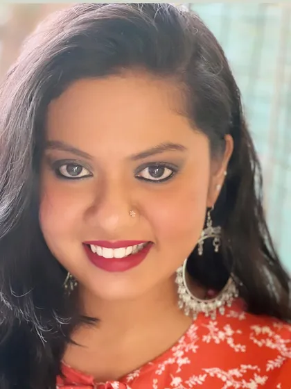 A confident and direct look from my gorgeous client. The smokey eye makeup defines and intensifies her gaze, while the bold lip color perfectly frames her smile.