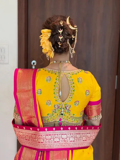 A detailed view of a traditional Marathi 'Khopa' hairstyle. I adorned this intricate bridal bun with a classic chandrakor accessory, ensuring the bride looks perfect from every angle.
