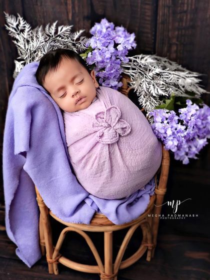 A classic portrait of the baby sleeping peacefully in the chair.