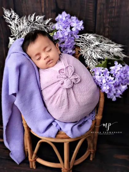 A classic portrait of the baby sleeping peacefully in the chair.